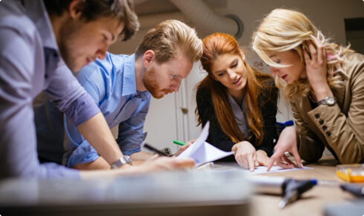 Colleagues reviewing documents together during a planning session.